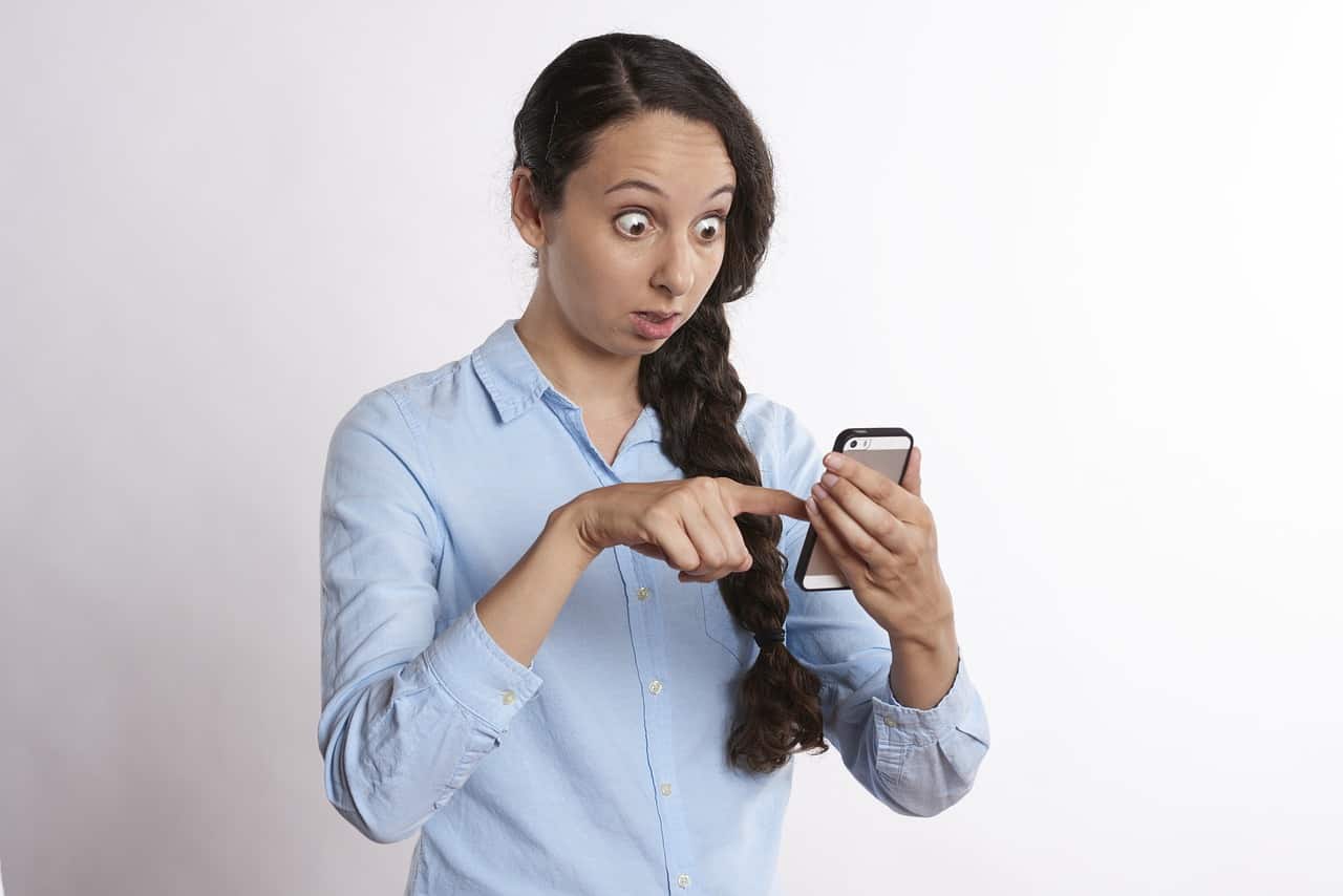 Woman staring anxiously at cellphone