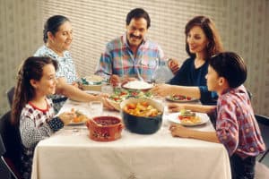 Family Eating At Dinner Table