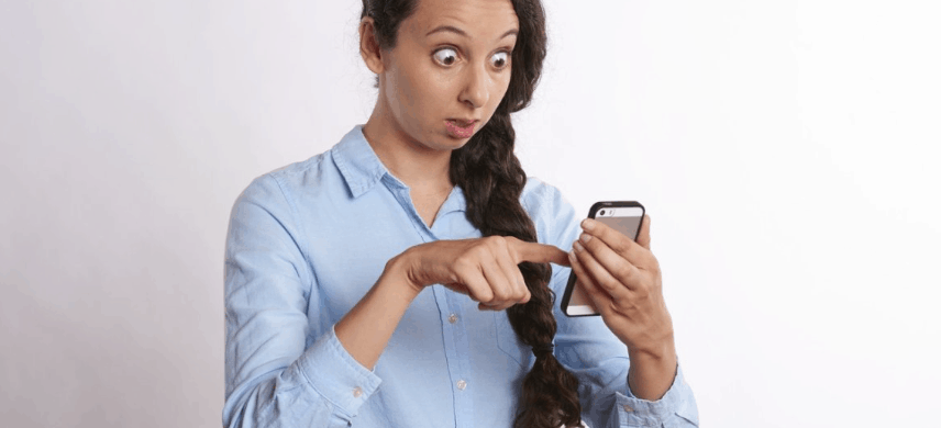 Bug-eyed woman staring at phone