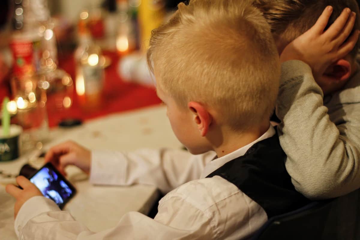 Boy on phone during dinner